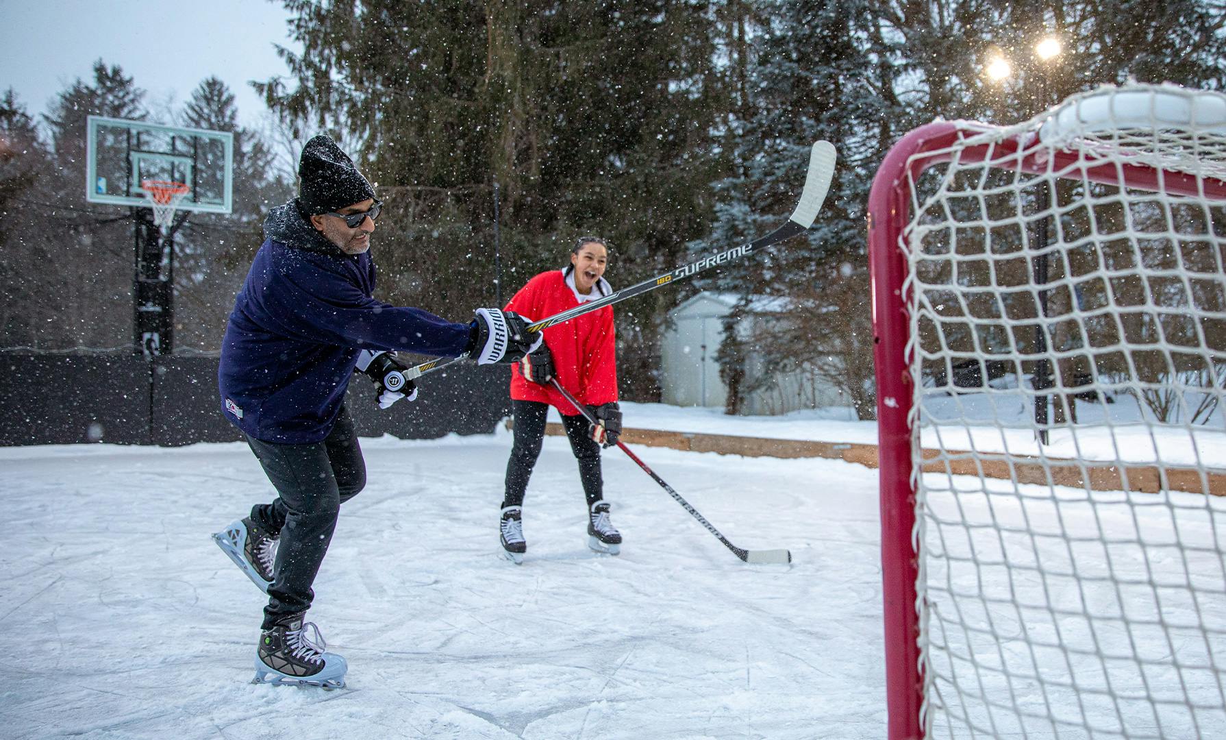 Two People Playing Ice Hockey