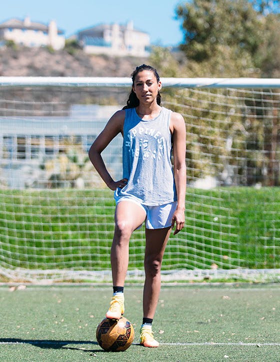 Christen Press with foot on soccer ball