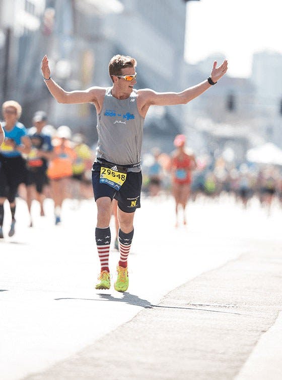 Runner arms raised Boston marathon