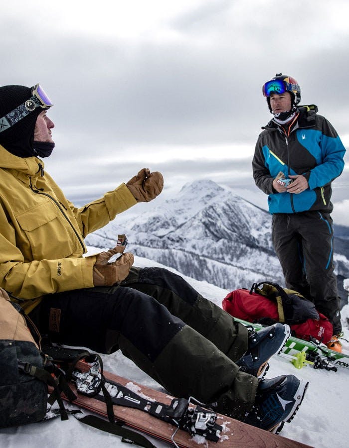 Skiers take snack break on mountain