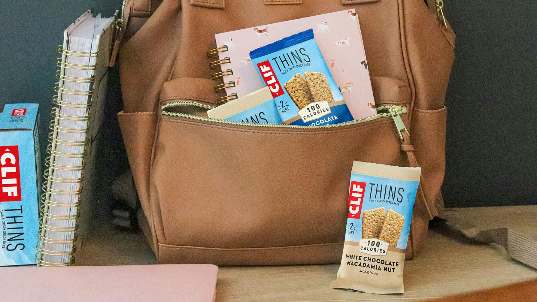 CLIF Thins with a backpack and notebooks