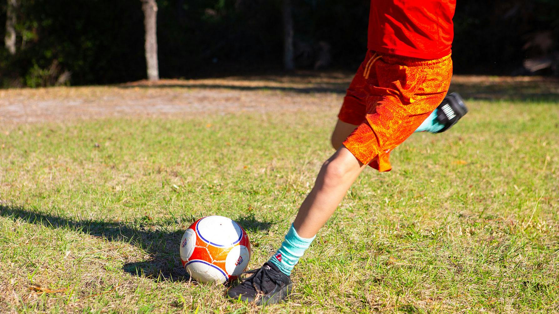 Kid kicking a soccer ball
