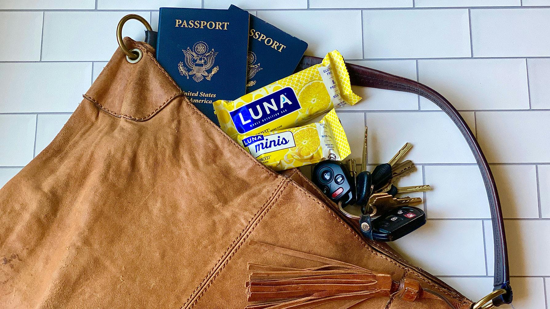 Purse packed with passports and LUNA Bars