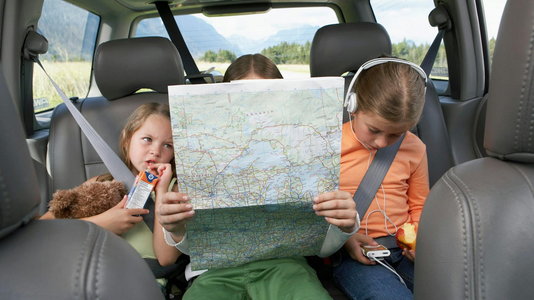 Kids with map on road trip