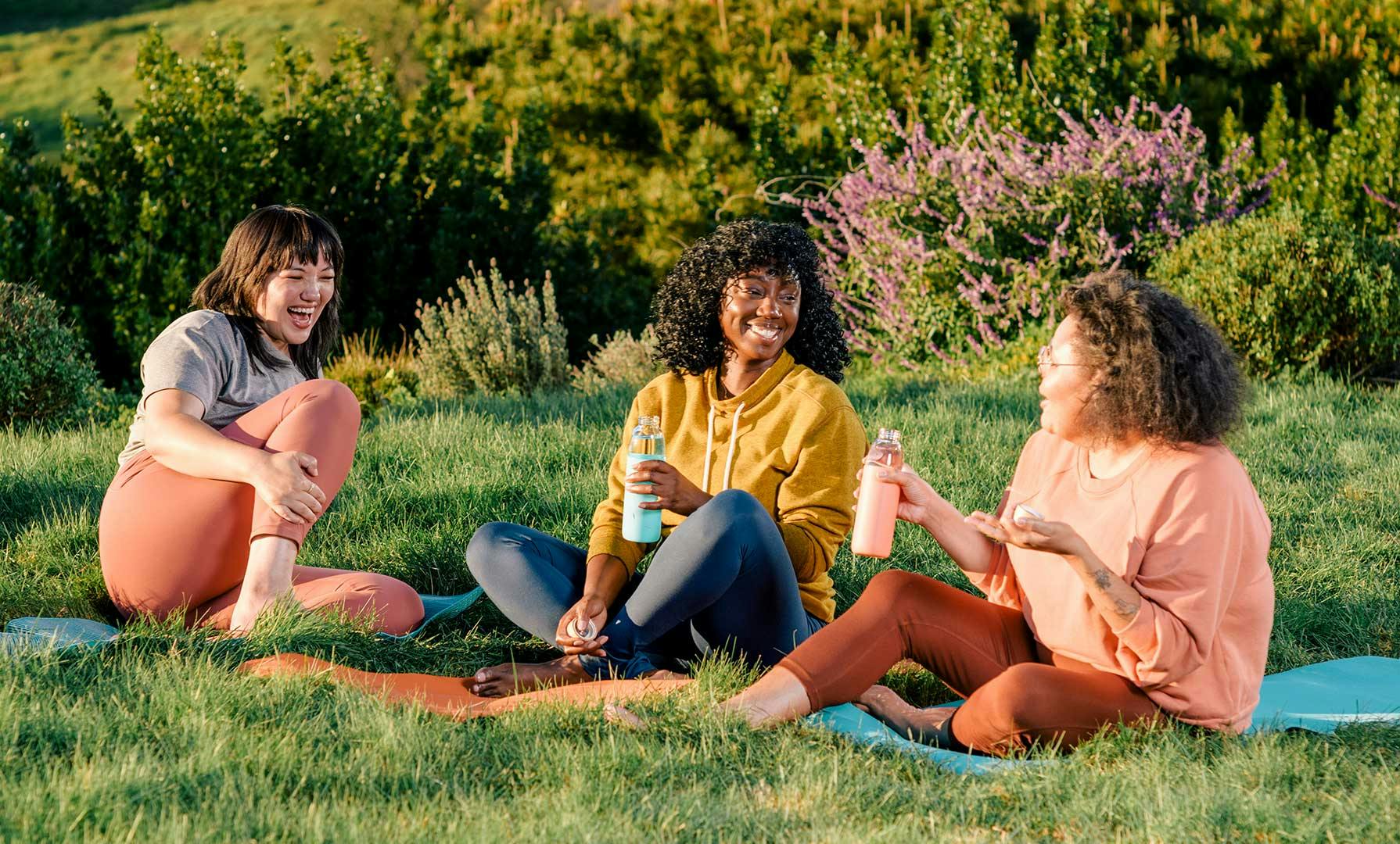 Women sitting on grass talking